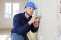 plasterer using scraper on wall Royalty Free Stock Photo