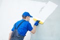 Refurbishment. Plasterer worker spackling a wall with putty