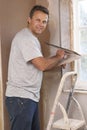 Plasterer Working On Interior Wall Royalty Free Stock Photo