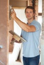 Plasterer Working On Wall