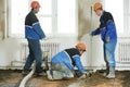 Plasterers concrete worker at floor work Royalty Free Stock Photo