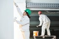 Plasterers at indoor wall work