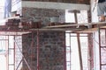 Plasterers making up brick wall