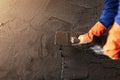 Plastering concrete to create industrial worker wall background with plastering tools, home improvement, quality concepts