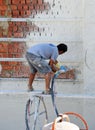 Plastering facade with injected mortar, mason working