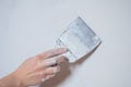 Plastering man hand with plaste and plaster spatula trowel in wall Royalty Free Stock Photo