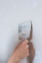 Plastering man hand with plaste and plaster spatula trowel in wall Royalty Free Stock Photo