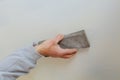 plastering man hand sanding the plaste in drywall seam plasterboard Royalty Free Stock Photo