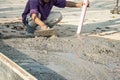 The tiler is working to smooth the cement surface. Royalty Free Stock Photo