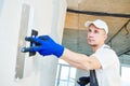 Plastering. Worker spackling a wall with putty Royalty Free Stock Photo