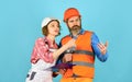 Plastering works. Couple look documents. Woman and man safety hard hat. Couple planning changes renovation apartment Royalty Free Stock Photo