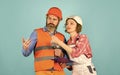 Plastering works. Couple look documents. Woman and man safety hard hat. Couple planning changes renovation apartment Royalty Free Stock Photo