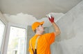 Plasterwork and painting preparation. craftsman applying plaster or filling on ceiling