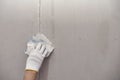 Plasterwork and wall painting preparation. close up hand of craftsman applying filling drywall patch