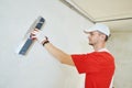 Plasterwork and wall painting preparation. craftsman applying plaster or filling