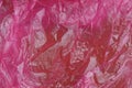 Plastic texture of a piece of crumpled red bright cellophane