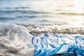 Plastic bag and bottles on the beach, seashore and water pollution concept. Royalty Free Stock Photo