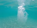 Plastic bag floating in the ocean, underwater waste. Ocean pollution concept. Global environmental problem. Copy space Royalty Free Stock Photo