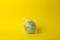 Plastic bag pollution concept. Earth globe in a plastic bag on a colored background. Plastic and waste pollution oceans, nature Royalty Free Stock Photo