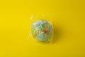 Plastic bag pollution concept. Earth globe in a plastic bag on a colored background. Plastic and waste pollution oceans, nature Royalty Free Stock Photo