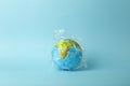 Plastic bag pollution concept. Earth globe in a plastic bag on a colored background. Plastic and waste pollution oceans, nature Royalty Free Stock Photo