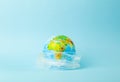 Plastic bag pollution concept. Earth globe in a plastic bag on a colored background. Plastic and waste pollution oceans, nature Royalty Free Stock Photo