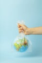 Plastic bag pollution concept. Earth globe in a plastic bag on a colored background. Plastic and waste pollution oceans, nature Royalty Free Stock Photo