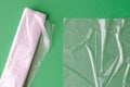 Plastic bag and polyethylene sack roll on green background