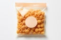 Plastic bag with uncooked pasta on white background, top view, mock up