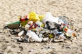 Plastic bags, bottles and other rubbish piled up in sand. Garbage on the beach Royalty Free Stock Photo