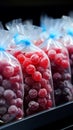 Plastic bags of frozen berries displayed tidily on a supermarkets cold shelf Royalty Free Stock Photo