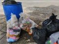 Plastic bags and garbage, Garbage bins full of trash in the public area.