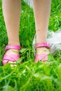 Plastic bags trash with children`s feet on green grass