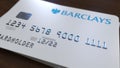Plastic bank card with logo of Barclays. Editorial conceptual 3D rendering