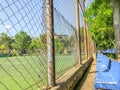 Plastic benches and flowering trees in the city park near the stadium