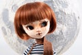 Plastic big eyes doll portrait with moon sky background Royalty Free Stock Photo