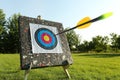 Plastic black arrow flying to archery target in park