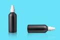 Plastic black cosmetic spray bottle, on blue background. Reflection. Packaging, storage, recycling. Royalty Free Stock Photo