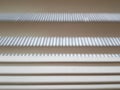 Plastic blinds in the form of white plates are seen on the window. Royalty Free Stock Photo