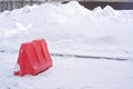 A plastic block on a background of white snow. Traffic difficulties due to the large amount of snow.