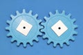 Plastic blue gears on a blue background. The concept of interaction, process. The photo