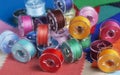 Plastic bobbins for a sewing machine with multi-colored threads