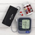 Plastic Bottle with Blood Pressure Support Pills and Digital Blood Pressure Monitor with Cuff. 3d Rendering Royalty Free Stock Photo