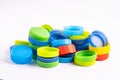 Plastic bottle colored screw caps for recycle waste on white background, container water lid