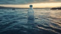 Plastic Bottle Floating in Calm Water at Sunset Royalty Free Stock Photo