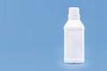 Plastic bottle for hydrogen peroxide, blue background, medicine concept, with copy space Royalty Free Stock Photo