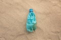 Plastic bottle lies on the beach and pollutes the sea. Spilled garbage on the beach