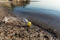 Plastic Bottle Lying On Beach Near Water Outdoors, Ecology Background Royalty Free Stock Photo