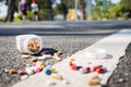 Plastic bottle of medication dropped on the street outdoor,drug scattered on the floor,jar of medicine with different pills