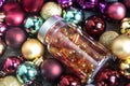 Plastic bottle with orange pills. Curcumine and vitamin D capsules on colourful Christmas balls. Coronavirus prevention